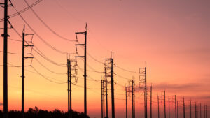 Power lines in front of a sunset