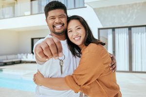 Young couple show keys to their new home