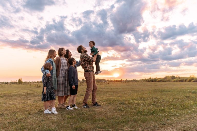 A family standing in front of a large acre of land